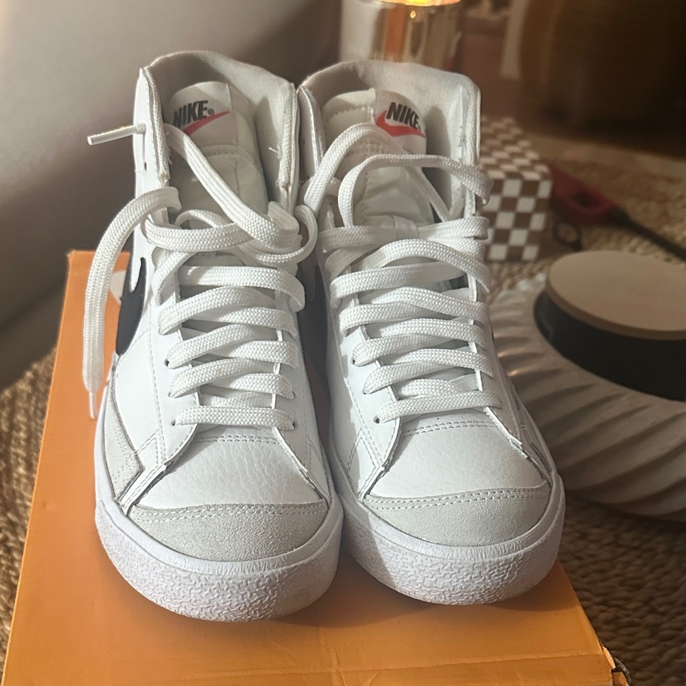 Nike White High-Top Sneakers with Black Swoosh and Pink Logo Accent